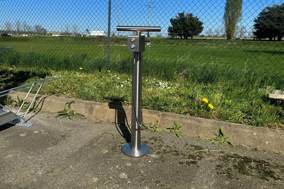 Pompe à vélo Boostair en inox installée en extérieur au bord d’une piste cyclable